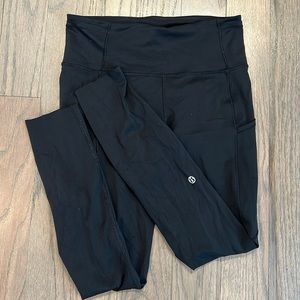 High waisted, Lululemon legging with pockets and reflective dots on legs.